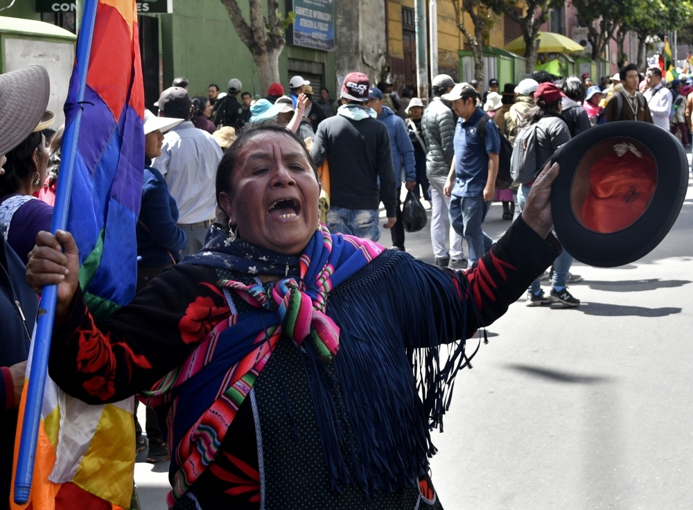 An indigenous woman attends the funeral procession of eight supporters of Bolivia's ex-President Evo Morales, killed when security forces lifted a siege on a fuel plant, in La Paz on Thursday. — AFP