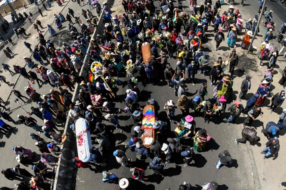 An indigenous woman attends the funeral procession of eight supporters of Bolivia's ex-President Evo Morales, killed when security forces lifted a siege on a fuel plant, in La Paz on Thursday. — AFP