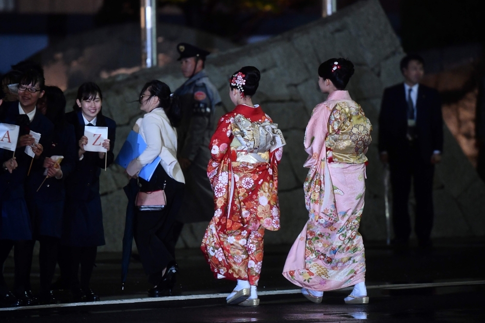 Japanese greeters clad in traditional attire are seen during Pope Francis' arrival in Tokyo's Haneda airport on Saturday. -AFP