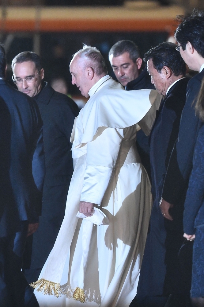 Japanese greeters clad in traditional attire are seen during Pope Francis' arrival in Tokyo's Haneda airport on Saturday. -AFP