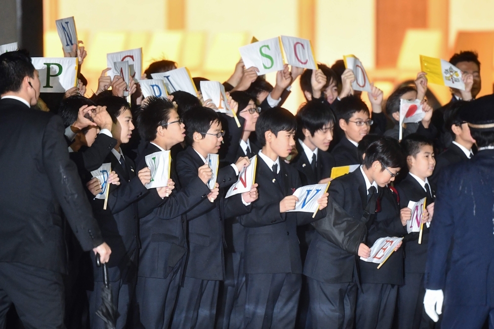 Japanese greeters clad in traditional attire are seen during Pope Francis' arrival in Tokyo's Haneda airport on Saturday. -AFP
