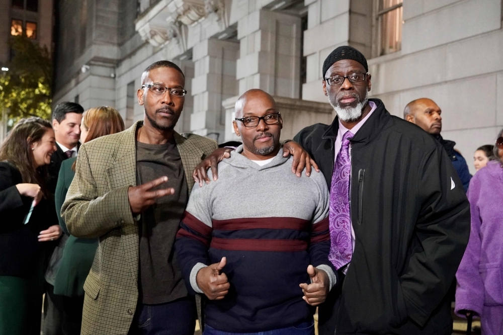 (From L to R)  Alfred Chesnut, Andrew Stewart and Ransom Watkins pose for a photo after their liberation in Baltimore on Monday. -AFP