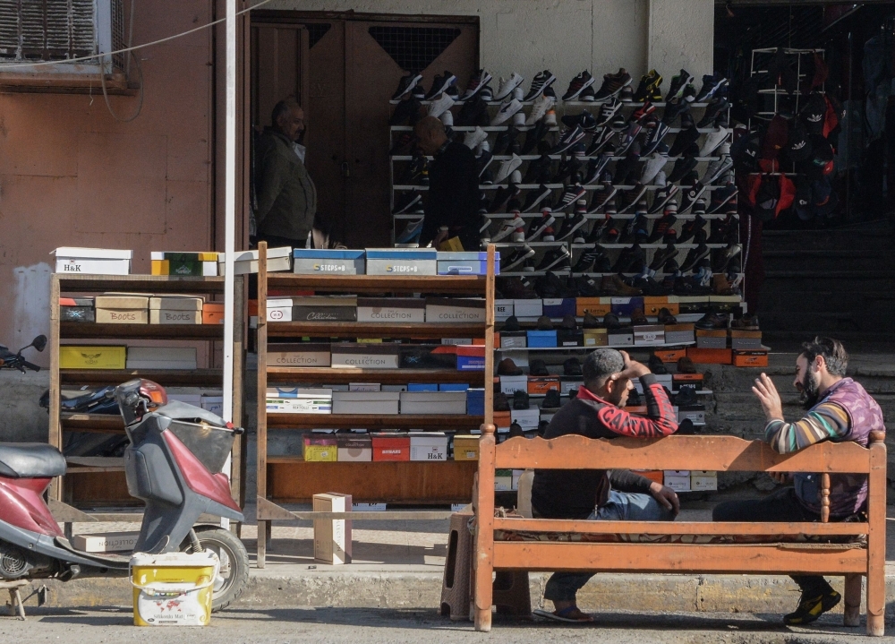 An Iraqi man and woman drink tea in a marketplace in the northern Iraqi city of Mosul, the capital of the Nineveh province, on Monday. — AFP