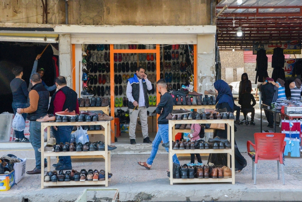 An Iraqi man and woman drink tea in a marketplace in the northern Iraqi city of Mosul, the capital of the Nineveh province, on Monday. — AFP
