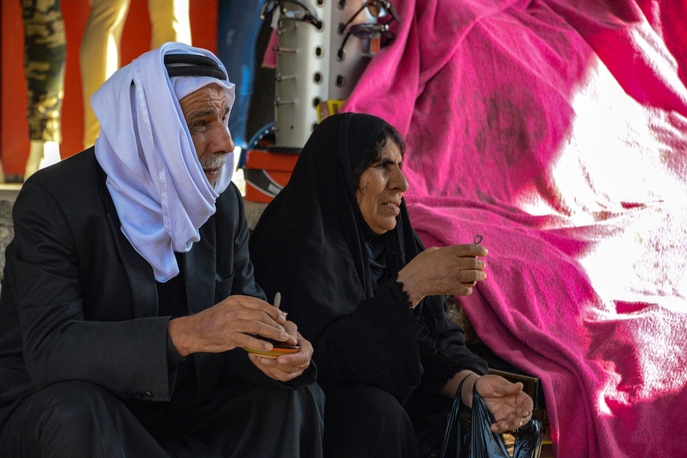 An Iraqi man and woman drink tea in a marketplace in the northern Iraqi city of Mosul, the capital of the Nineveh province, on Monday. — AFP