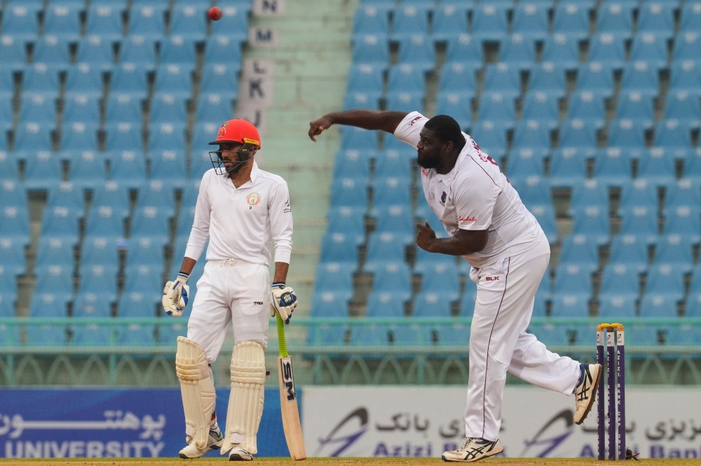 West Indies' Rahkeem Cornwall (R) delivers a ball during the third day of the only cricket Test match between Afghanistan and West Indies at the Ekana Cricket Stadium in Lucknow on Friday. — AFP