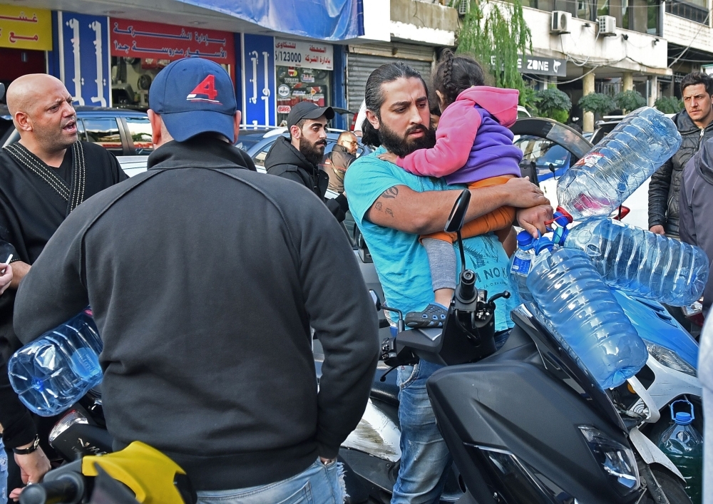 Lebanese people queue in front of a petrol station in Beirut's Cola district on Friday, following an open strike called for by the Syndicate of Fuel Station Owners. — AFP