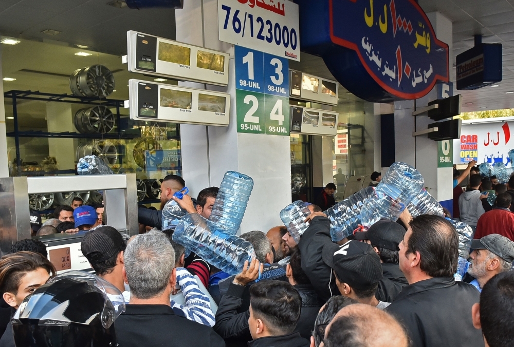 Lebanese people queue in front of a petrol station in Beirut's Cola district on Friday, following an open strike called for by the Syndicate of Fuel Station Owners. — AFP