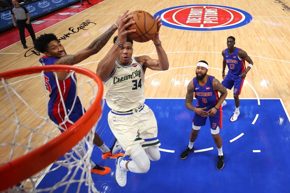 Giannis Antetokounmpo No. 34 of the Milwaukee Bucks drives to the basket past Langston Galloway No. 9 of the Detroit Pistons during the second half at Little Caesars Arena on Wednesday in Detroit, Michigan. Milwaukee won the game 127-103. — AFP