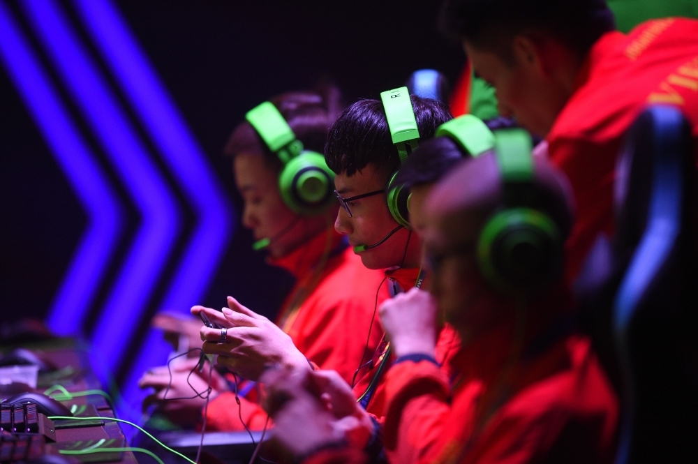Gamers from the Vietnam team compete in the qualifying rounds of the eSports event between Malaysia and Vietnam at the SEA Games (Southeast Asian Games) in Manila on Thursday. — AFP