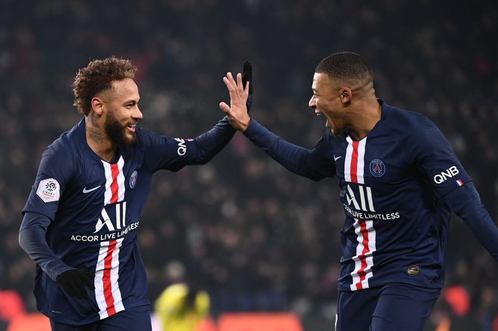 Paris Saint-Germain's Brazilian forward Neymar, left, is congratulated by Paris Saint-Germain's French forward Kylian Mbappe after scoring his team's first goal during the French L1 football match between Paris Saint-Germain (PSG) and FC Nantes (FCN) at the Parc des Princes in Paris, on Wednesday. — AFP