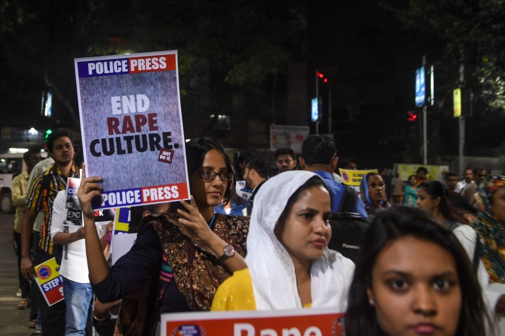 A demonstrator holds a placard to protest against sexual assaults on women, following the alleged gang rape and murder of a 27-year-old veterinarian in Hyderabad and other recent sexual assaults, during a march in Kolkata on Wednesday. — AFP