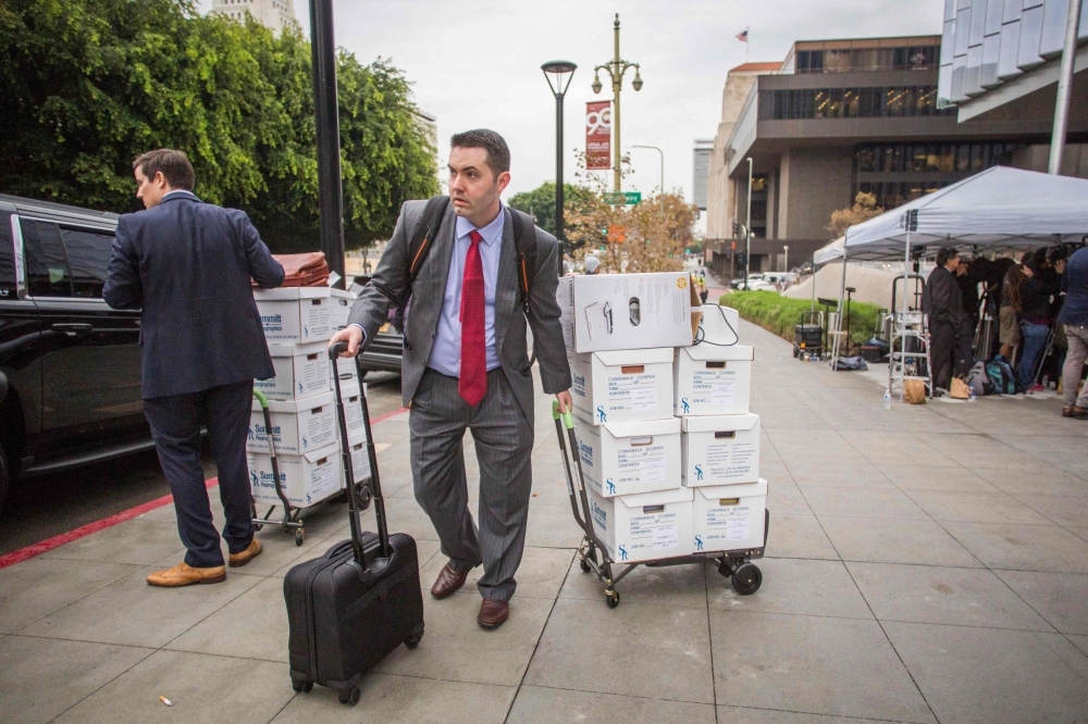 Alex Spiro, leader of Elon Musk attorneys team, talks to the press as he leaves the US District Court, Central District of California in Los Angeles on Friday. -AFP