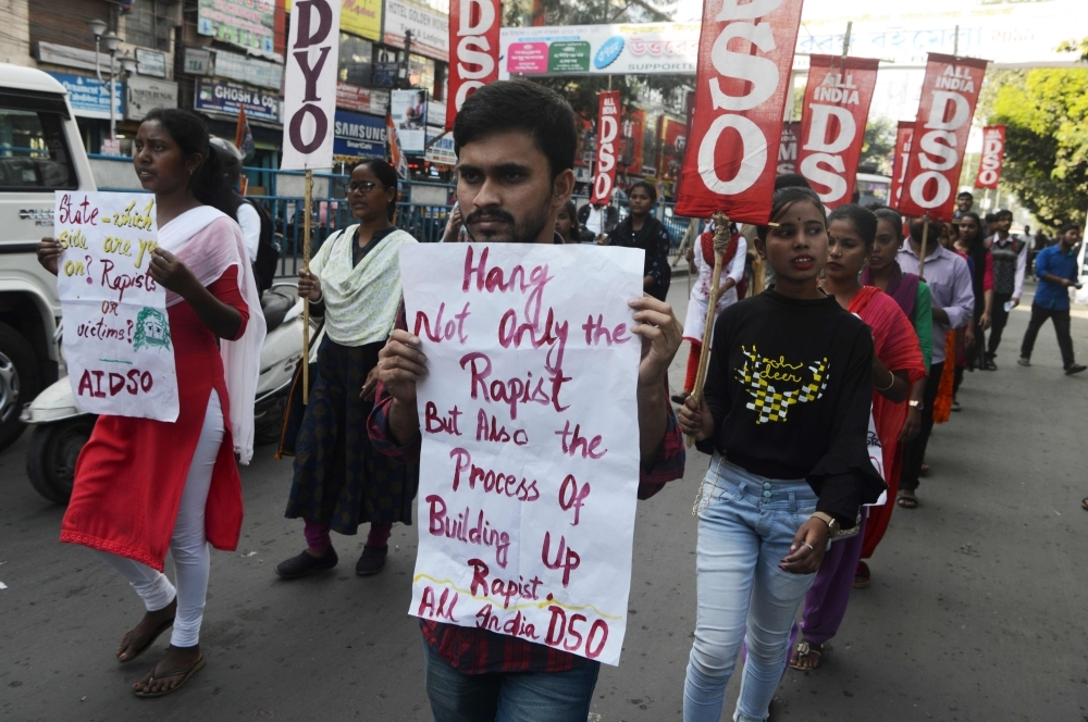 Indian youths and students hold placards against the recent rapes throughout the country during a demonstration in Siliguri on Saturday. -AFP