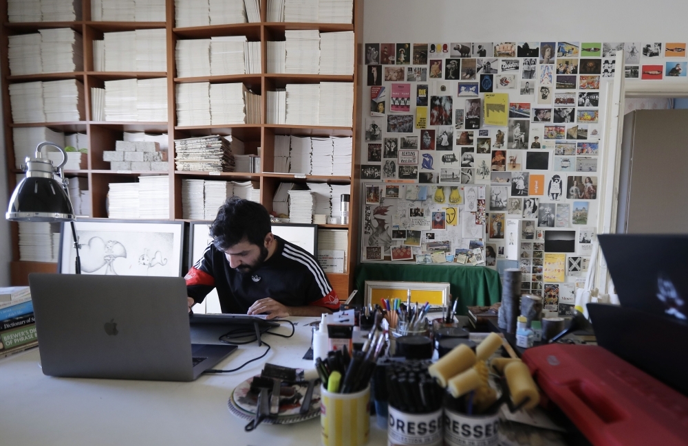  Lebanese cartoonist Bernard Haje works at his studio in Jal el-Dib, on the northern outskirts of the capital Beirut, on December 4, 2019. -AFP