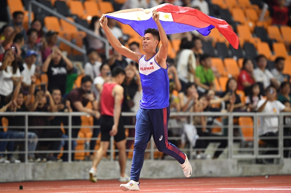 Kristina Marie Knott from the Philippines celebrates after winning in the women's 200m athletics event at the SEA Games (Southeast Asian Games) at the athletics stadium in Clark, Capas, Tarlac province north of Manila, on Saturday. — AFP
