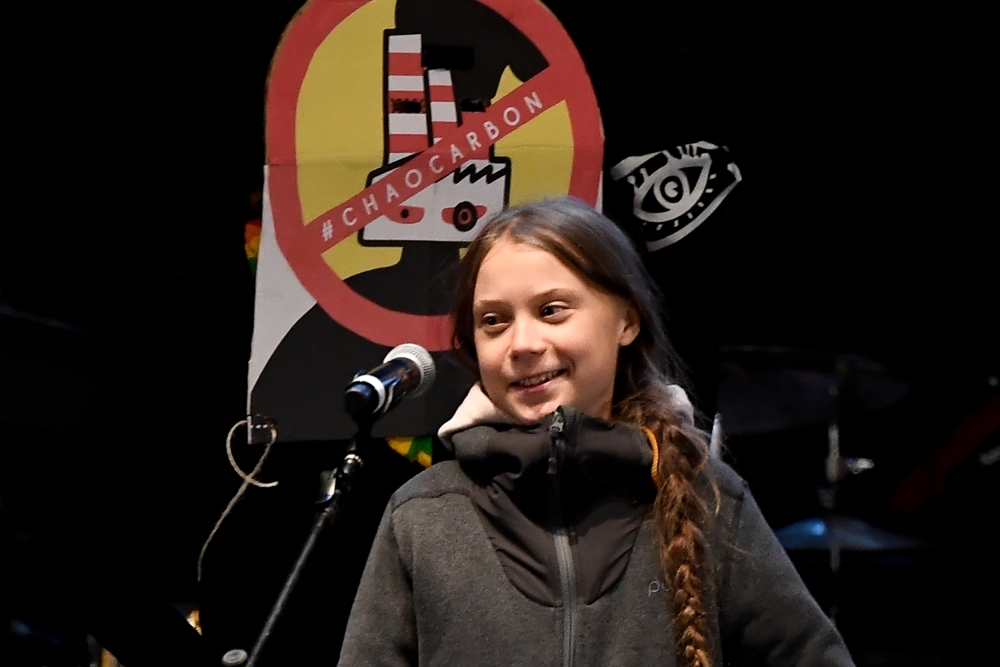 Swedish climate activist Greta Thunberg delivers a speech after a mass climate march to demand urgent action on the climate crisis from world leaders attending the COP25 summit, in Madrid, on Friday. Thousands of activists from around the globe will simultaneously hit the streets of Madrid and Santiago.  — AFP