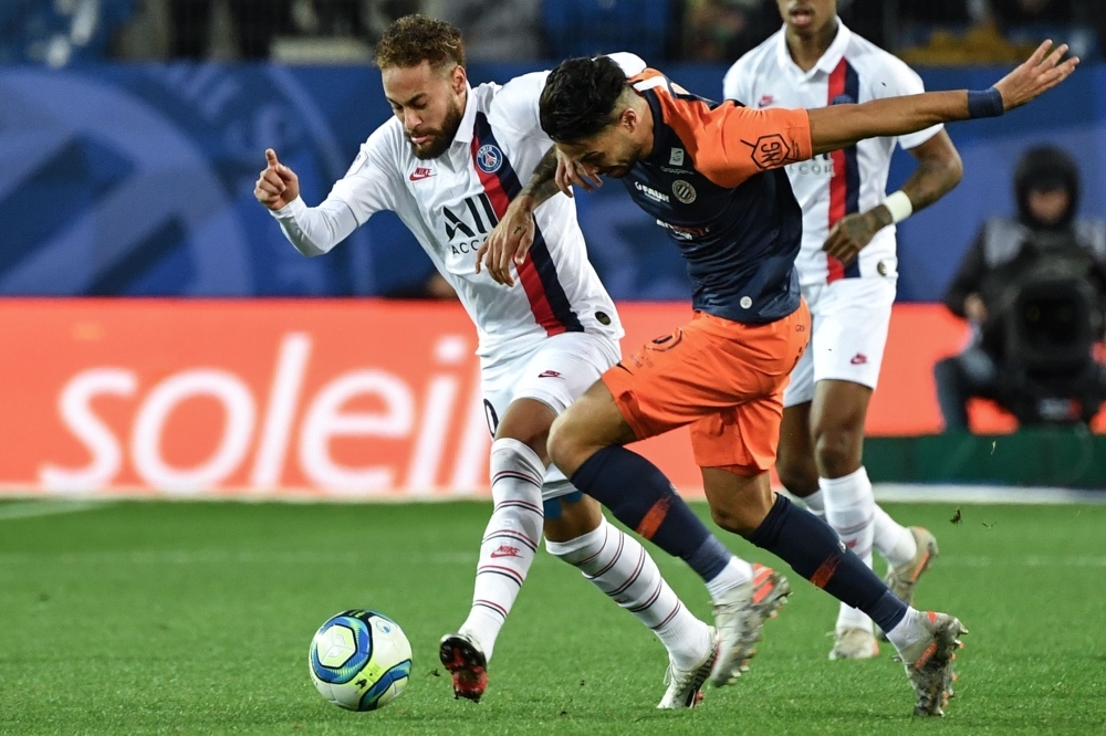 Paris Saint-Germain's Brazilian forward Neymar fights for the ball with Montpellier's Portuguese defender Pedro Mendes (R) during the French L1 football match between Montpellier Herault Sport Club (MHSC) and Paris Saint-Germain (PSG) at the Mosson stadium in Montpellier, southeastern France, on Saturday. — AFP