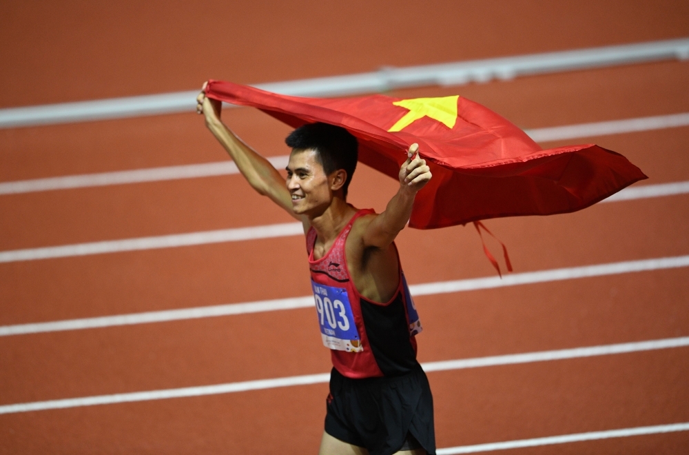 Duong Van Thai of Vietnam celebrates after winning in the men's 1,500m athletics event at the SEA Games (Southeast Asian Games) in the athletics stadium in Clark City, Capas, Tarlac province north of Manila, on Sunday. — AFP