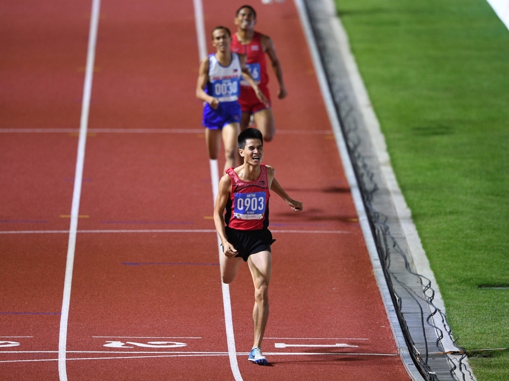 Duong Van Thai of Vietnam celebrates after winning in the men's 1,500m athletics event at the SEA Games (Southeast Asian Games) in the athletics stadium in Clark City, Capas, Tarlac province north of Manila, on Sunday. — AFP