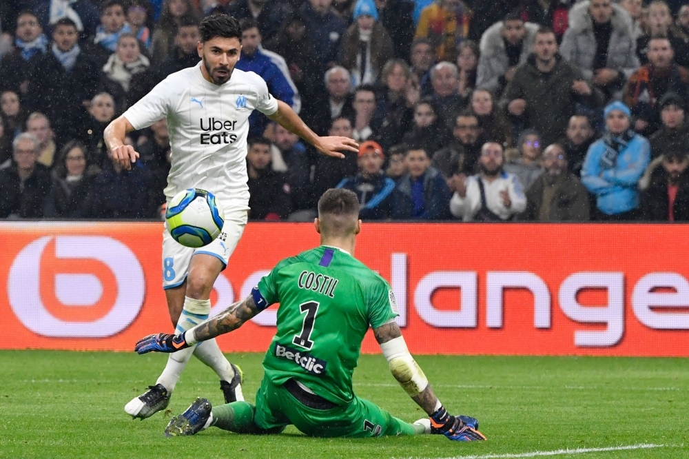 Marseille's Serbian forward Nemanja Radonjic (L) shoots and scores a goal past Bordeaux's French goalkeeper Benoit Costil (2nd-R) during the French L1 football match between Olympique de Marseille (OM) and FC Girondins de Bordeaux (FCGB) at the Velodrome Stadium in Marseille, southern France, on Sunday. — AFP