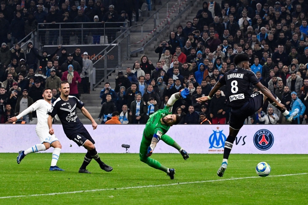 Marseille's Serbian forward Nemanja Radonjic (L) shoots and scores a goal past Bordeaux's French goalkeeper Benoit Costil (2nd-R) during the French L1 football match between Olympique de Marseille (OM) and FC Girondins de Bordeaux (FCGB) at the Velodrome Stadium in Marseille, southern France, on Sunday. — AFP