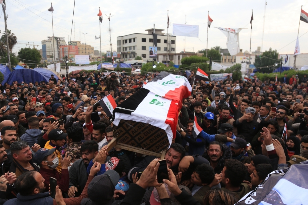 Iraqi mourners walk in the funeral of a prominent civil society activist was shot dead the previous night while returning home from anti-government protests, in Iraq's shrine city of Karbala, south of the capital baghdad, on Monday. — AFP
