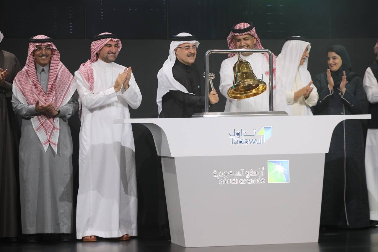 Saudi Aramco and Tadawul top officials mark the oil giant's first day of trading in Riyadh.  