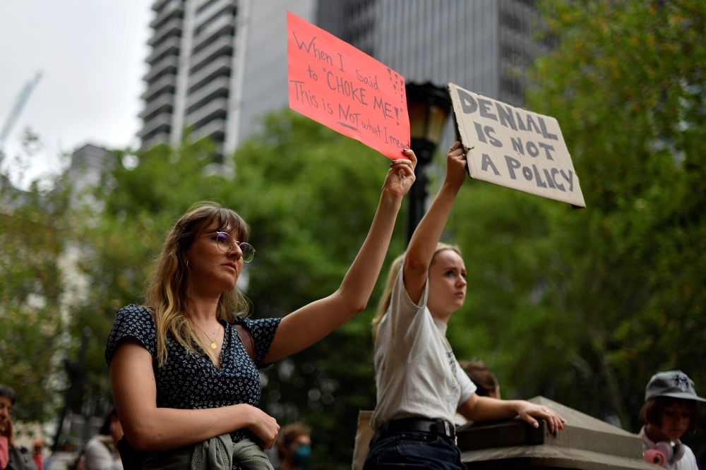 People chant slogans as they take part in a climate protest rally in Sydney on Wednesday. — AFP
