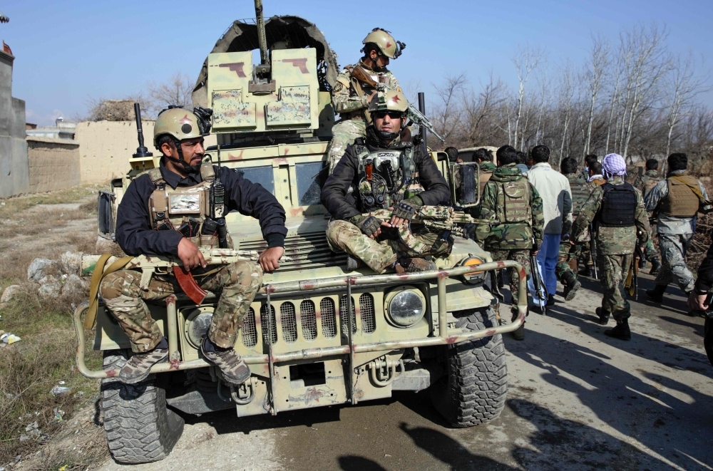 Afghan security forces arrive at the site of a car bombing near the largest US military in Afghanistan, north of Kabul in Parwan province, on Wednesday. — AFP