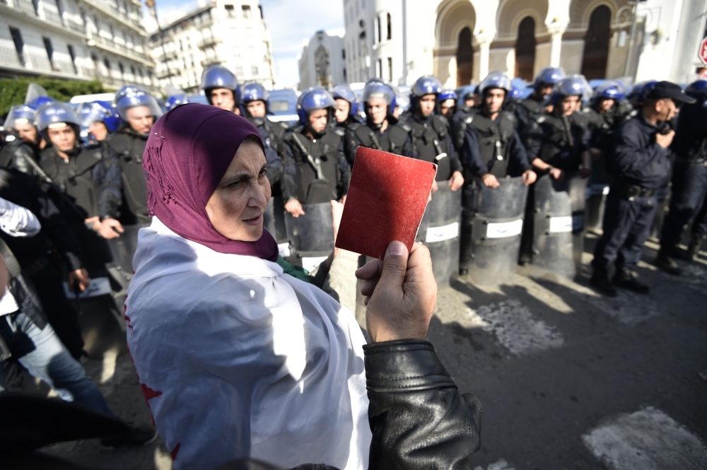 An Algerian protester holds up a red card during an anti-government demonstration in the capital Algiers on Wednesday. — AFP