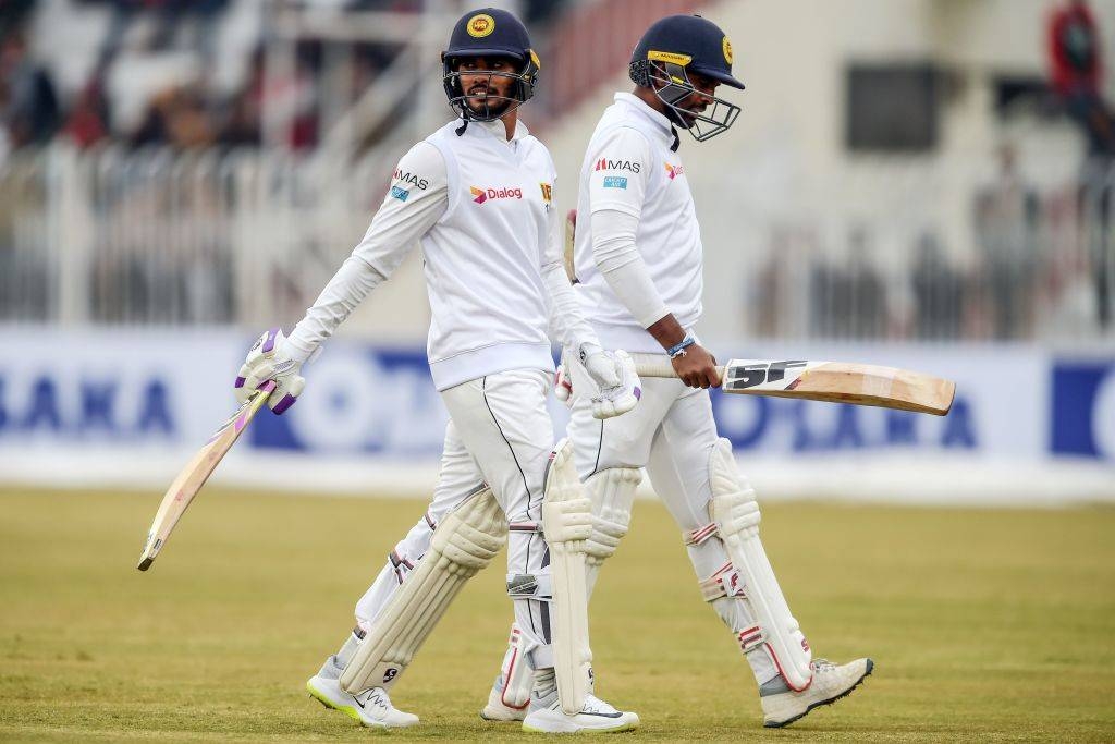 Sri Lankan batsmen walk off the pitch at the close of play during the first Test against Pakistan in Rawalpindi, as heavy rain and bad light hit the second day.