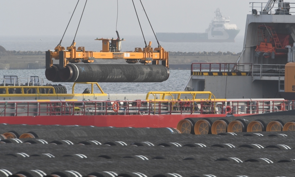 Tubes for the construction of the Nord Stream 2 pipeline are being loaded on a ship at the Mukran port in Sassnitz on the Baltic Sea island of Ruegen, northeastern Germany, on Thursday. — AFP