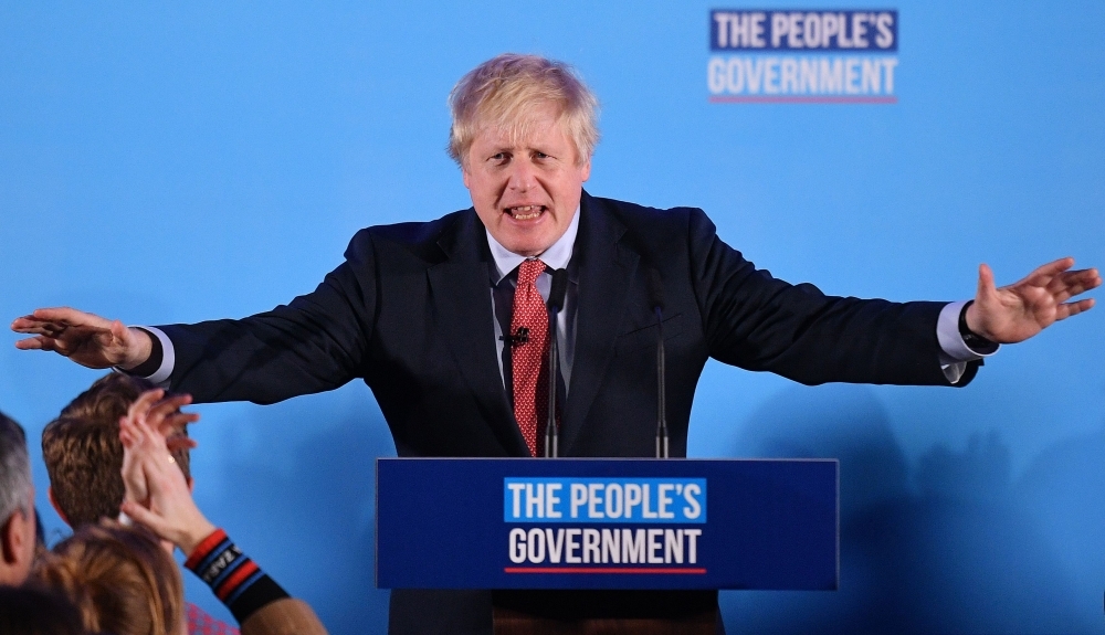 Britain's Prime Minister and leader of the Conservative Party, Boris Johnson speaks during a campaign event to celebrate the result of the general election in central London on Friday. — AFP