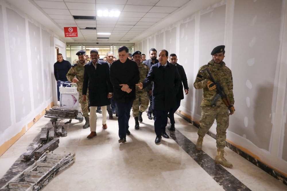 Libya's Tripoli-based Government of National Accord (GNA) Prime Minister Fayez Al-Sarraj, center, tours the Mitiga International Airport as it undergoes maintenance, ahead of it's reopening, in Tripoli in this Dec. 11, 2019 file photo. — AFP