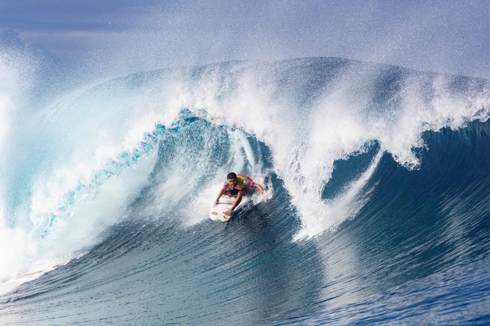 In this file photo taken on Aug. 28, 2019 Brazilian surfer Adriano DeSouza competes in the 2019 Tahiti Pro at Teahupoo, Tahiti. Tahiti is to host surfing events at 2024 Paris Olympics, the organizers announced on Thursday. — AFP