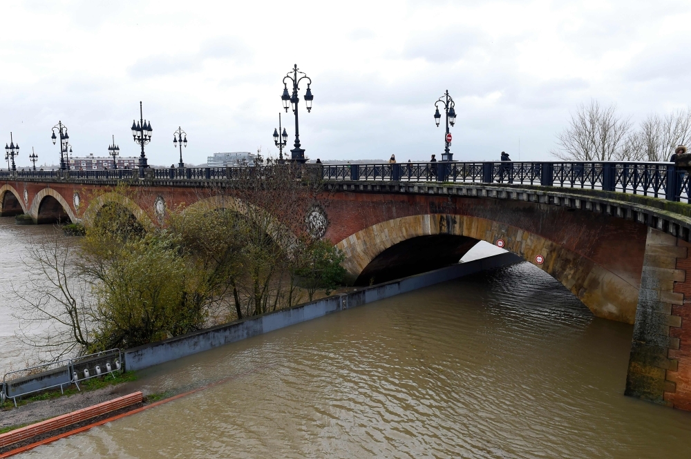 The Garonne river overflows due to strong winds and heavy rains in Bordeaux, southwestern France, on Friday. — AFP