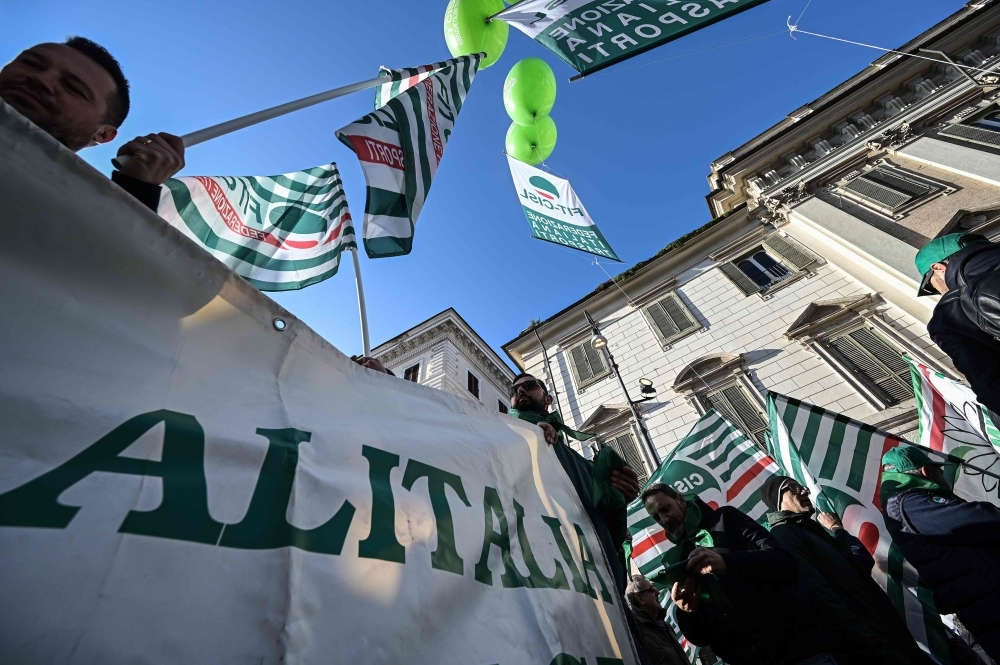 Workers from Italian airline Alitalia, workers and unions from all sectors coming from all over Italy, particularly from the South (Mezzogiorno) gather for a protest in downtown Rome on Dec. 10, 2019, against the industrial crisis, the closure of factories, lay-offs and for public and private investment, best working conditions and social protection. — AFP