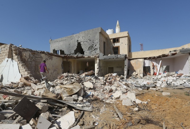Libyans check the site of an air strike on the southern outskirts of the capital Tripoli in this October 14, 2019 file photo. — AFP