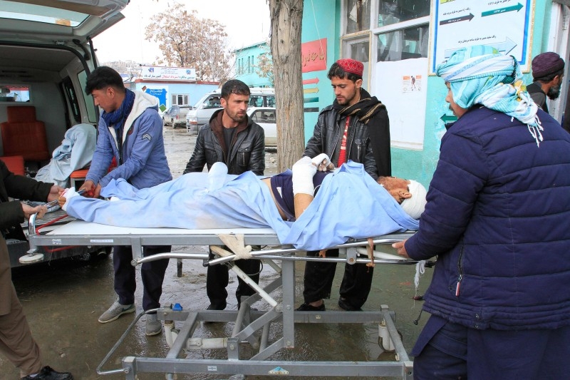 A wounded man is brought to a hospital after a vehicle was hit by a roadside bomb in Ghazni on Friday. — AFP