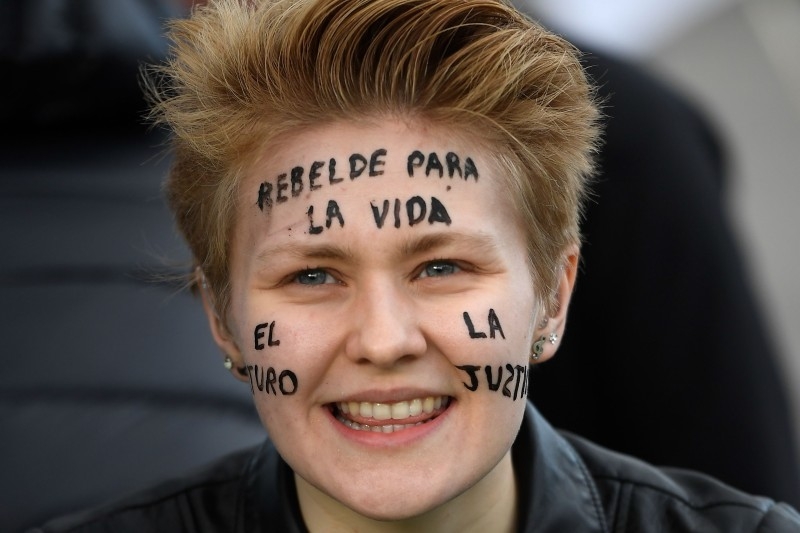 A demonstrator takes part in a protest on climate emergency, called by environmental groups including Extinction Rebellion and Fridays For Future, outside the UN Climate Change Conference COP25 at the 'IFEMA - Feria de Madrid' exhibition centre, in Madrid, on Friday. — AFP