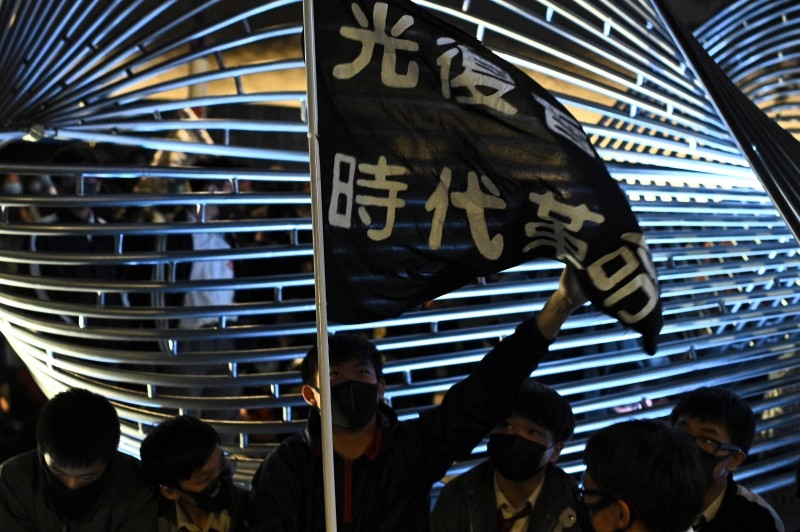 A light installation of 'Free HK' is presented while high school students light up their mobile phones as they sing 'Glory to Hong Kong' during a pro-democracy rally at the Salisbury Garden in Tsim Sha Tsui district of Hong Kong on Friday. -AFP