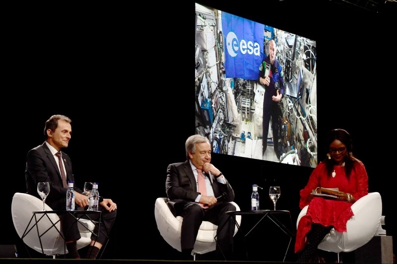 Pedro Duque (L), Spain's caretaker Minister of Science, Innovation and Universities and Antonio Guterres (C), Secretary-General of the United Nations, take part in a conversation with Luca Parmitano (on screen), current international space station commander at the UN Climate Change Conference COP25 at the 'IFEMA - Feria de Madrid' exhibition centre, in Madrid, on Dec. 11. - AFP