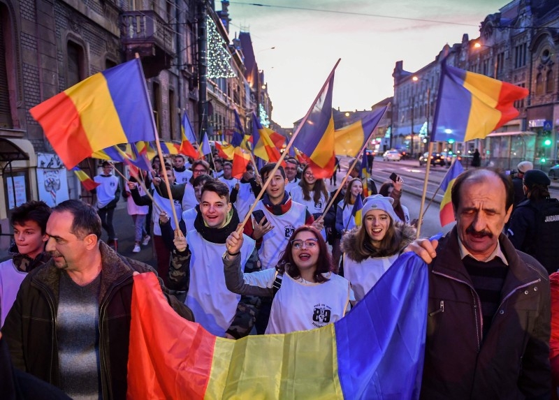 People march on the streets of Timisoara during a commemoration on the occasion of the 30 years of the Romanian Revolution's first victims in Timisoara, Romania on Sunday. -AFP
