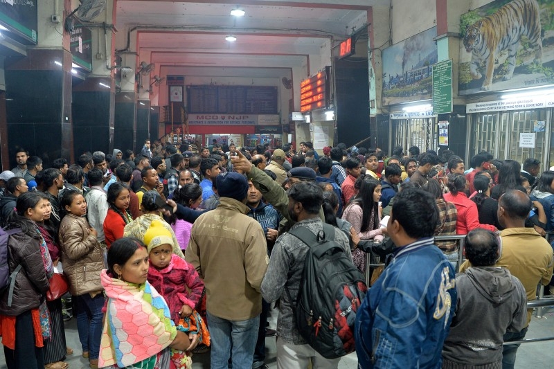 Commuters wait as trains has been cancelled at New Jalpaiguri Railway station on the outskirts of Siliguri on Sunday, following protest against the Indian government's Citizenship Amendment Bill (CAB). -AFP