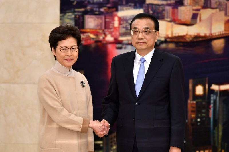 This handout photograph taken and released by the Hong Kong Government on Monday shows Chinese Premier Li Keqiang (R) meeting with Hong Kong Chief Executive Carrie Lam during her annual duty visit, in Hong Kong Hall at the Great Hall of the People in Beijing. -AFP