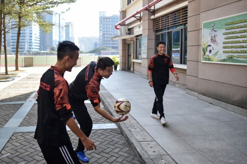 Former Manchester United and Chinese international footballer Dong Fangzhuo, right, watches as children train, in Xiamen in China's Fujian province, in this Dec. 10, 2019 file photo. — AFP