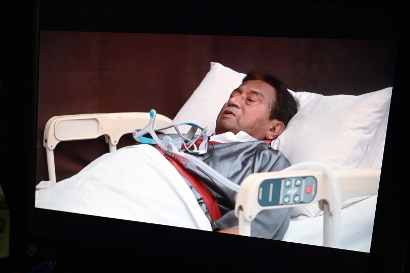 A video statement of the ailing exiled former Pakistani military ruler Pervez Musharraf in a hospital bed in Dubai is pictured on a screen in Islamabad on Thursday. — AFP