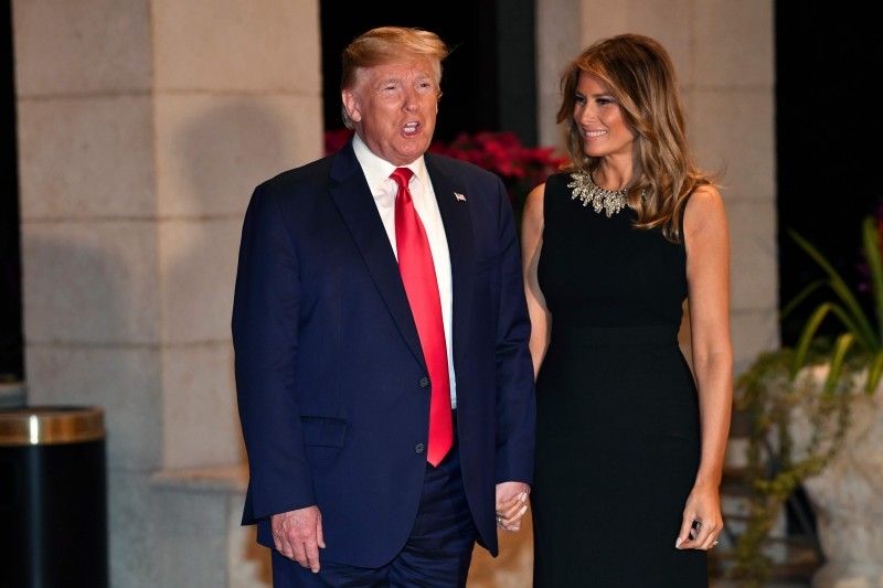 US President Donald Trump and First Lady Melania Trump arrive for a Christmas Eve dinner with his family at Mar-A-Lago in West Palm Beach, Florida, on Tuesday. — AFP