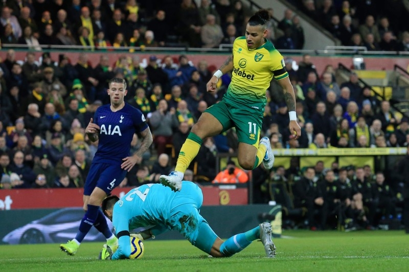 Norwich City's Cuban-born German midfielder Onel Hernandez (R) is beaten to the ball by Tottenham Hotspur's Argentinian goalkeeper Paulo Gazzaniga (L) during the English Premier League football match at Carrow Road in Norwich, eastern England on Saturday. — AFP